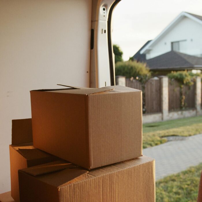 View inside a delivery van with stacked cardboard boxes ready for moving.